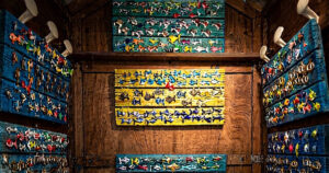 Interno di una cabina balneare in legno decorata con pannelli colorati pieni di pesciolini artistici in ceramica per la mostra Una Cabina d'Artista.