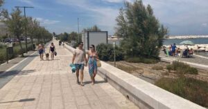 persone a passeggio sul waterfront di san girolamo bari