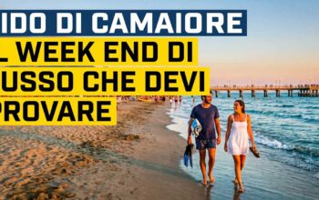 Coppia che passeggia sulla spiaggia di Lido di Camaiore con vista sul pontile
