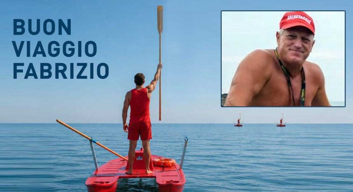Bagnino su pattino di salvataggio alza un remo verso il cielo in segno di rispetto, con un ritratto di Fabrizio Valente e la scritta "BUON VIAGGIO FABRIZIO".